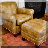 F28. One of a pair of Hancock & Moore leather chairs with ottomans. 32”h x 35”w x 36”d 